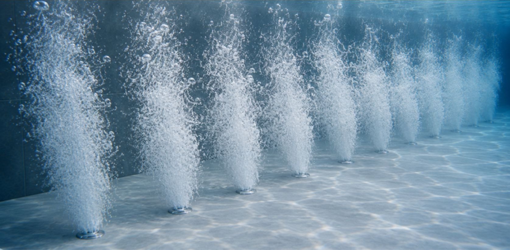 Bicos de air blower em funcionamento no fundo da piscina